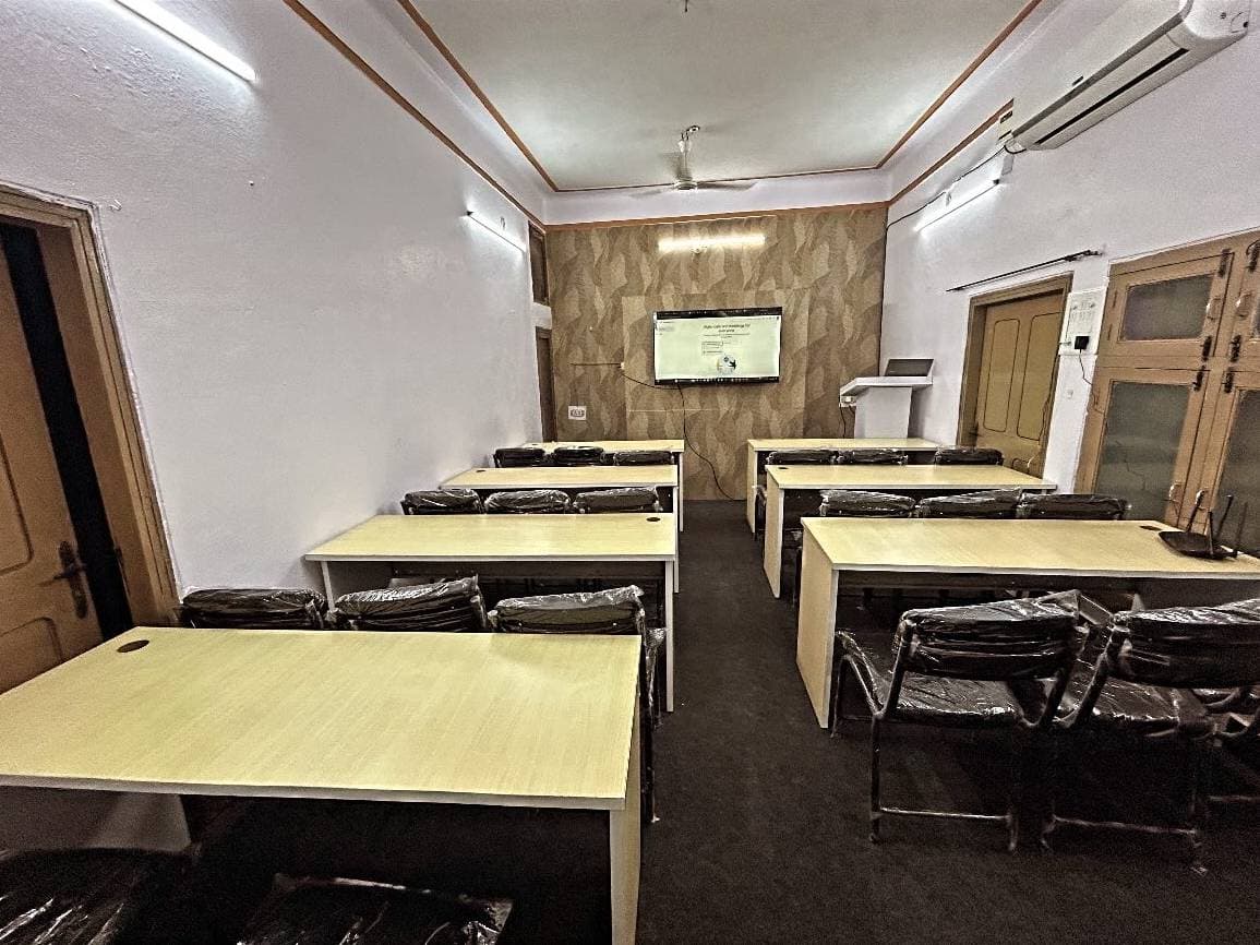 The computer lab from the doorway, the teaching screen at the far end