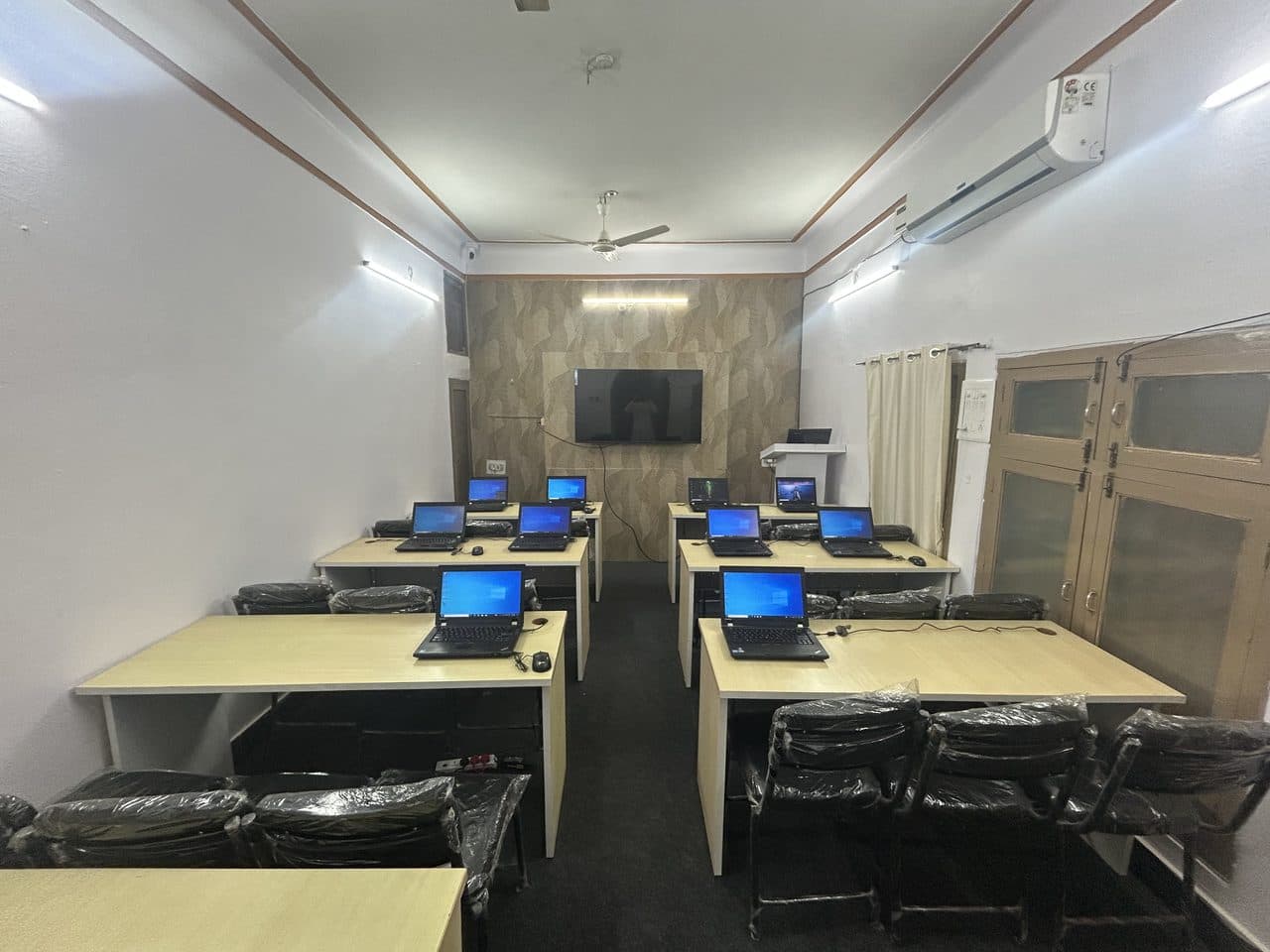 The NextGen computer lab, laptops set out at desks before a batch